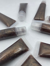 Load image into Gallery viewer, Your Glam Secret’s “Coco Kisses” A lip-hydrating gloss that combines maximum hydration, comfort, and shine with an instant and long-lasting softening effect enriched with olive and grapeseed oil to give your lips a super satisfying layer of moisture and yummy scent of chocolate 🍫 
